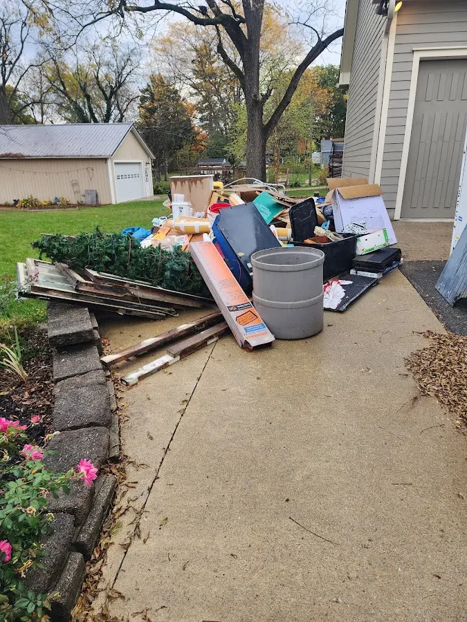 Dumpster being loaded with debris for Roofing Dumpster Rental in Cannon